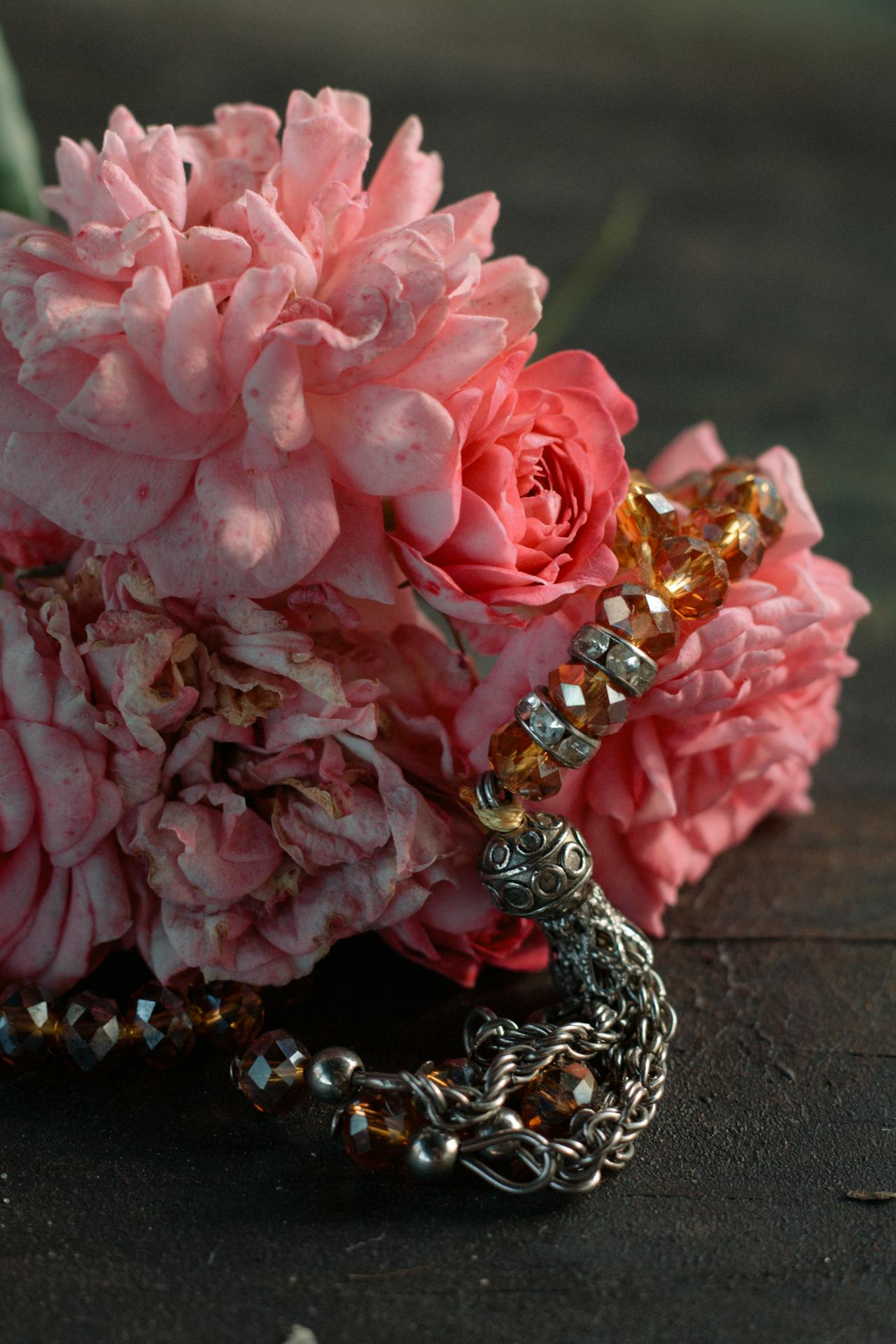 polished thulite beads on a string showing the range from pale rose to deeper pink tones