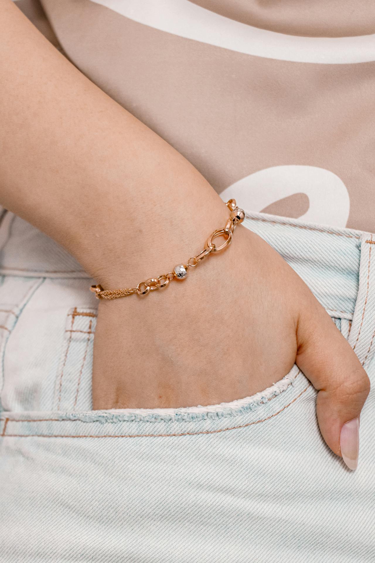 a styled outfit featuring a gold cuff bracelet paired with a casual button-up shirt, showing the versatility of the piece