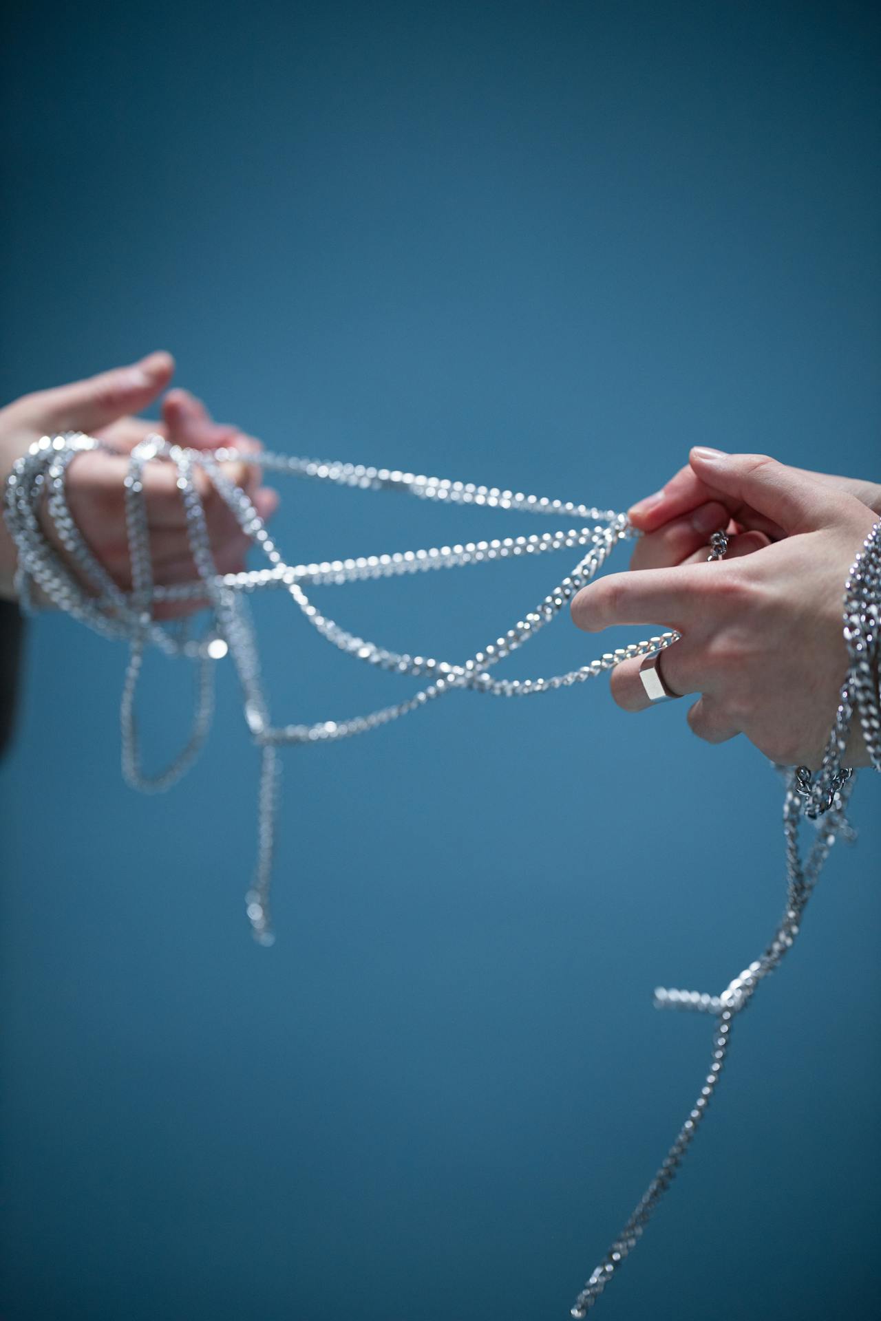 a tangled necklace ball pulled from a suitcase pocket, illustrating the problem most travelers have experienced