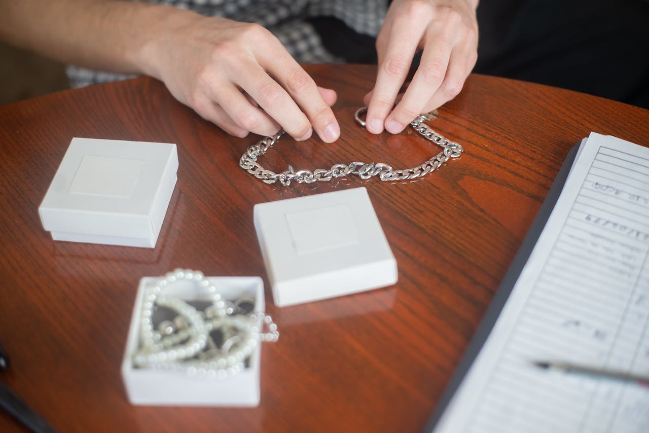 necklaces laid out on plastic wrap with a second layer being placed on top