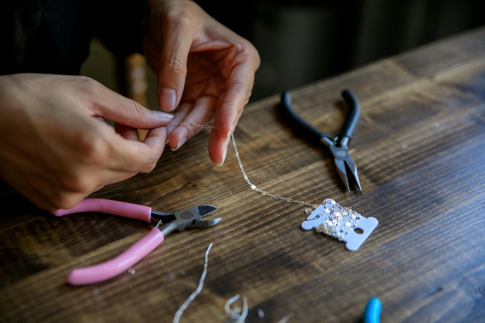 four necklace clasps laid out side by side: lobster, spring ring, toggle, and magnetic